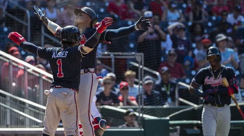Johan Camargo celebrates with Braves teammate Ozzie Albies (left) after hitting a two-run home run in the 10th inning against the Washington Nationals June 23, 2019, at Nationals Park in Washington, DC.