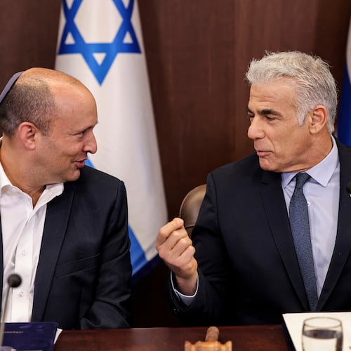 Israel's then caretaker Prime Minister Yair Lapid, right, talks with former Prime Minister Naftali Bennett during the weekly cabinet meeting in Jerusalem, on Sunday, Sept. 18, 2022. (Ronaldo Schemidt/Pool Photo via AP)