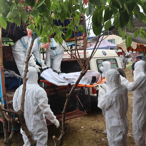 Rescuers carry bodies of flash flood victims for a mass burial in Chitwan, Nepal, Saturday, Aug. 29, 2026. (AP Photo/Nisha Shrestha)