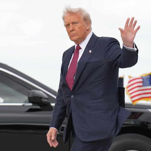 President Donald Trump waves after walking off of Air Force One, Wednesday, Nov. 5, 2025, upon arrival to Miami International Airport, in Miami. (AP Photo/Jacquelyn Martin)