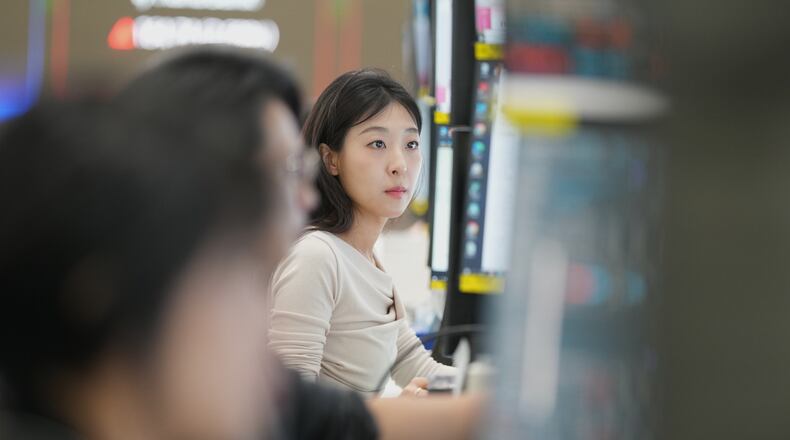 A dealer watches computer monitors at a dealing room of Hana Bank in Seoul, South Korea, Monday, May 4, 2026. (AP Photo/Lee Jin-man)