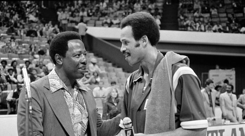 Lou Hudson, right, forward for the Los Angeles Lakers, is congratulated by baseball's Hank Aaron after a ceremony retiring Hudson's jersey as a player for the Atlanta Hawks in Atlanta, Ga., Oct. 29, 1977. Aaron's jersey as an Atlanta Brave was retired by the team after he was traded to the Milwaukee Brewers. Hudson was honored before the Hawks-Lakers NBA game, which the Hawks won 102-95. (AP Photo/Joe Sebo)