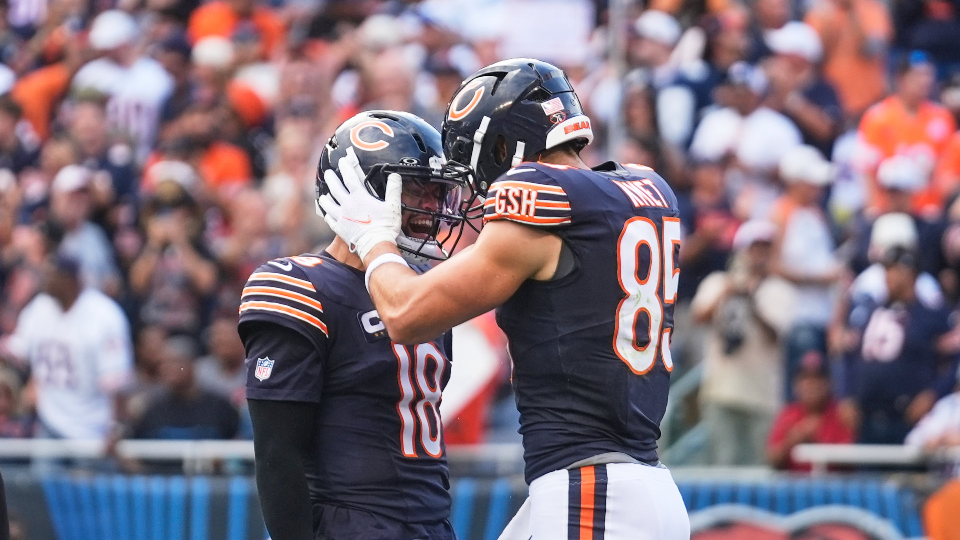 Chicago Bears' Caleb Williams (18) and Cole Kmet (85) celebrate after Kmet caught a touchdown pass in the first half of an NFL football game against the Dallas Cowboys Sunday, Sept. 21, 2025, in Chicago. (AP Photo/Erin Hooley)
