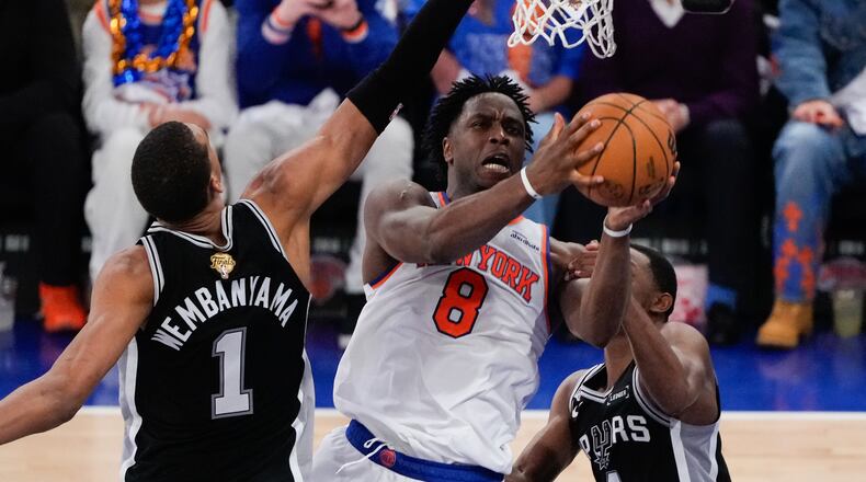 New York Knicks forward Og Anunoby (8) shoots between San Antonio Spurs forward Victor Wembanyama (1) and guard De'aaron Fox (4) during the first half of Game 4 of the NBA Finals basketball series, Wednesday, June 10, 2026, in New York. (AP Photo/Ross D. Franklin)