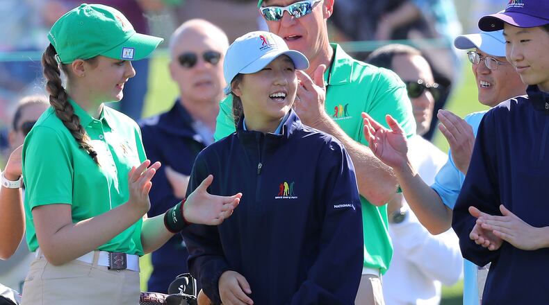 Sara Im (center), Duluth, Ga., is all smiles on the 18th green as she is announced the winner of the putting championship and overall championship for 12-13 girls in the Drive Chip & Putt National Finals at Augusta National Golf Club on Sunday. (Curtis Compton/ccompton@ajc.com)