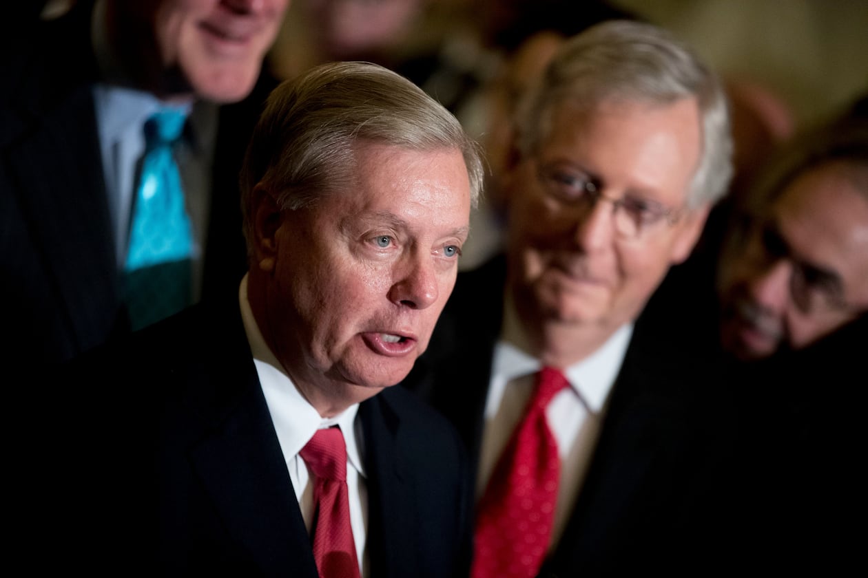 Sen. Lindsey Graham — pictured alongside Sen. Mitch McConnell in 2017 — died Saturday night of what the preliminary medical examiner report says was a tear in his aorta. (Andrew Harnik/AP)