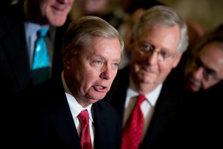 Sen. Lindsey Graham — pictured alongside Sen. Mitch McConnell in 2017 — died Saturday night of what the preliminary medical examiner report says was a tear in his aorta. (Andrew Harnik/AP)