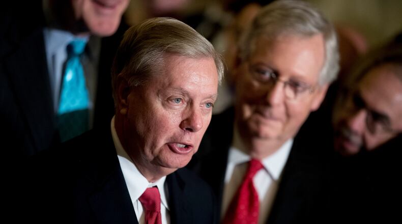 Sen. Lindsey Graham — pictured alongside Sen. Mitch McConnell in 2017 — died Saturday night of what the preliminary medical examiner report says was a tear in his aorta. (Andrew Harnik/AP)
