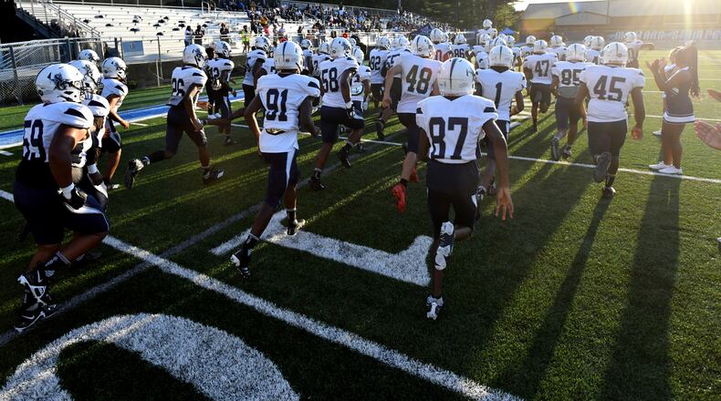 August 26 , 2022 Norcross - South Gwinnett players run onto the football field before their football game against Meadowcreek at Meadowcreek High School in Norcross on Friday, August 26, 2022. (Hyosub Shin / Hyosub.Shin@ajc.com)