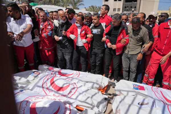 FILE.- Mourners gather around the bodies of 8 Red Crescent emergency responders, recovered in Rafah a week after an Israeli attack, as they are transported for burial from a hospital in Deir al-Balah, Gaza Strip, on Monday, March 31, 2025. (AP Photo/Abdel Kareem Hana,File)