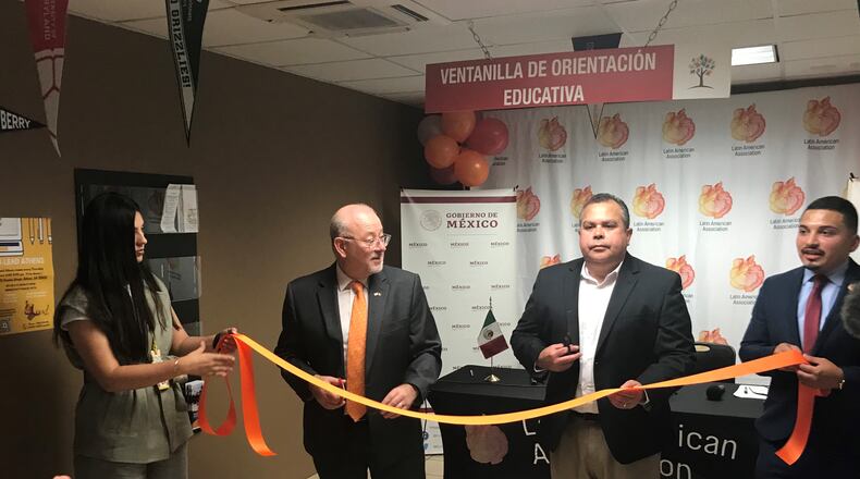 Mexican consul general Javier Diaz de Leon (second from left) and Latin American Association CEO Santiago Marquez (second from right) participate in a ceremonial ribbon cutting at the Mexican consulate in Atlanta after announcing a partnership meant to boost community members' access to educational opportunities. Wednesday, July 12, 2023.