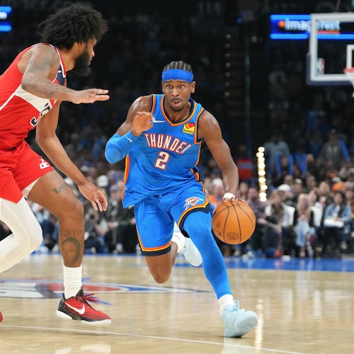 Oklahoma City Thunder guard Shai Gilgeous-Alexander, right, drives past Washington Warriors forward Marvin Bagley III, left, during the second half of an NBA basketball game, Thursday, Oct. 30, 2025, in Oklahoma City. (AP Photo/Kyle Phillips)