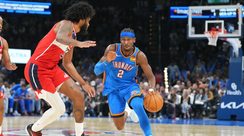 Oklahoma City Thunder guard Shai Gilgeous-Alexander, right, drives past Washington Warriors forward Marvin Bagley III, left, during the second half of an NBA basketball game, Thursday, Oct. 30, 2025, in Oklahoma City. (AP Photo/Kyle Phillips)