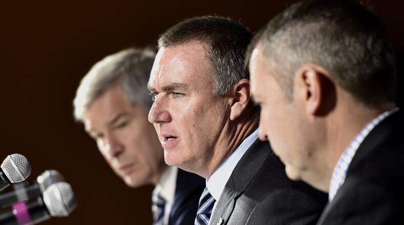 Shawn Elliott, center, speaks at a news conference where he was introduced as the head football coach for Georgia State in Atlanta, Georgia, on Friday, December 9, 2016. He was joined by Georgia State president, Mark Becker, left, and athletic director Charlie Cobb, right. (DAVID BARNES / DAVID.BARNES@AJC.COM)