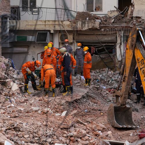 Rescue workers continue to search for people trapped under the debris of a collapsed building in New Delhi, India, Monday, Sept. 7, 2026. (AP Photo/Manish Swarup)