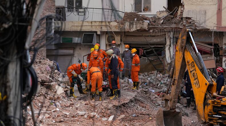 Rescue workers continue to search for people trapped under the debris of a collapsed building in New Delhi, India, Monday, Sept. 7, 2026. (AP Photo/Manish Swarup)