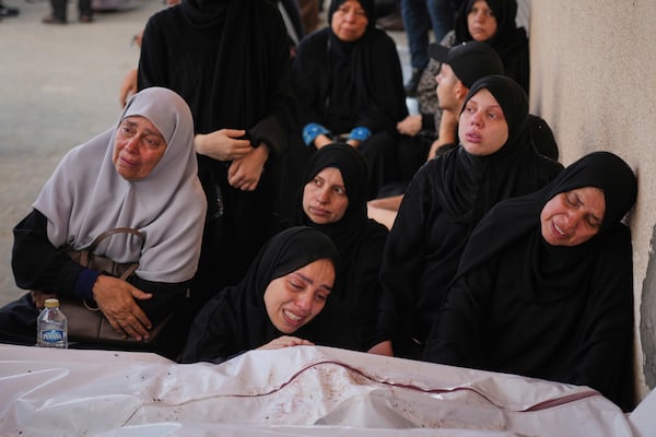 Mourners attend the funeral of their relatives who were killed in an Israeli bombardment, in Deir al-Balah, Gaza Strip, Saturday, July 12, 2025. (AP Photo/Abdel Kareem Hana)