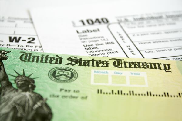 A tax refund check and income tax forms.