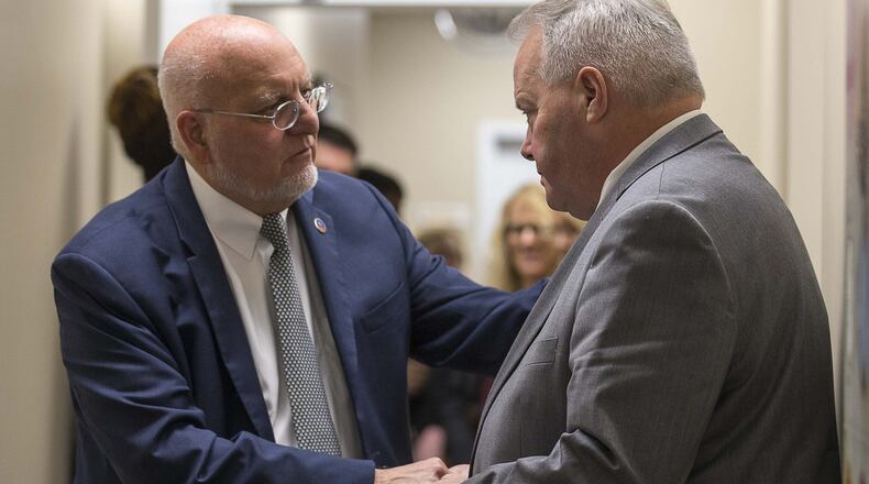 Director of the Centers for Disease Control and Prevention, Dr. Robert Redfield (left), shakes hands with Larry Lehman, CEO and President of the Positive Impact Health Centers, during a tour of the Positive Impact Health Center in Decatur.(ALYSSA POINTER/ALYSSA.POINTER@AJC.COM)