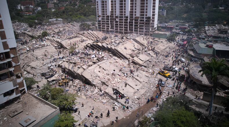 Residents and rescue workers search through the rubble two days after an earthquake struck La Guaira, Venezuela, Friday, June 26, 2026. (AP Photo/Juan Pablo Arraez)