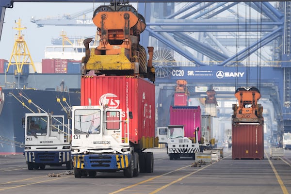 Cranes unload shipping containers from trucks at Jakarta International Container Terminal (JICT) at Tanjung Prior Port in Jakarta, Indonesia, Friday, April 11, 2025.(AP Photo/Tatan Syuflana)