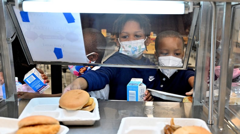 Kindergartner King Langford, 5, picks up his lunch at Cliftondale Elementary School in College Park on Wednesday, October 13. Metro Atlanta school districts are having to be creative to revise and rework menus because of national food supply issues. The COVID-19 pandemic has made it difficult for districts to get some of their usual food items. (Hyosub Shin / Hyosub.Shin@ajc.com)