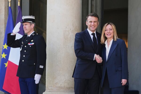 French President Emmanuel Macron, center, greets Italy's Prime Minister Giorgia Meloni during arrivals for a summit on Ukraine at the Elysee Palace in Paris, Thursday, March 27, 2025 . (AP Photo/Thibault Camus)