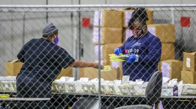 January 6, 2021 Atlanta: Fulton County election workers resumed counting ballots at 9:30 a.m. on Wednesday, Jan. 6, 2021 an hour later than election officials had planned. Fulton elections director Richard Barron told county commissioners Wednesday morning there are 7,500 absentee ballots left to be uploaded. Fulton spokeswoman Jessica Corbitt said there are 2,700 left to be processed at Georgia World Congress Center. Mail-in ballots take more time to count because they are more complicated to tabulate. There are a variety of reasons, including an adjudication process that allows ballots with stray markings or other irregularities to be reviewed by poll watchers from each party. The adjudication process for those remaining ballots will begin today at 3 p.m. That means Fulton’s ballots won’t be uploaded until after 3 p.m., Barron said. The process will occur at the county’s English Street warehouse, which is where votes are actually uploaded once they’ve been adjudicated. “We have been unfairly, and I’ll state that unequivocally, unfairly criticized by any number of people,” Fulton Commission Chairman Robb Pitts said during a virtual press conference, “no justification whatsoever.” State election officials said voting generally went smoothly Tuesday, with short lines and average wait times of about 1 minute. (John Spink / John.Spink@ajc.com)