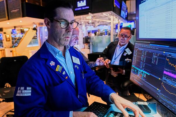 Specialist John McNierney, left, works with traders on the floor of the New York Stock Exchange, Thursday, May 29, 2025. (AP Photo/Richard Drew)