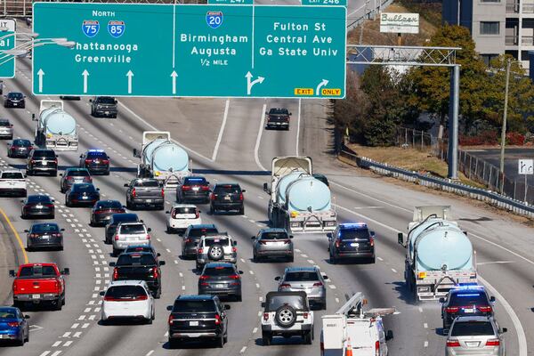 Four Georgia Department of Transportation trucks drive northbound on the connector, treating the roads with brine before the arrival of the winter storm in January 2025. The GDOT advises drivers to use extreme caution while they are working. (Miguel Martinez/AJC)