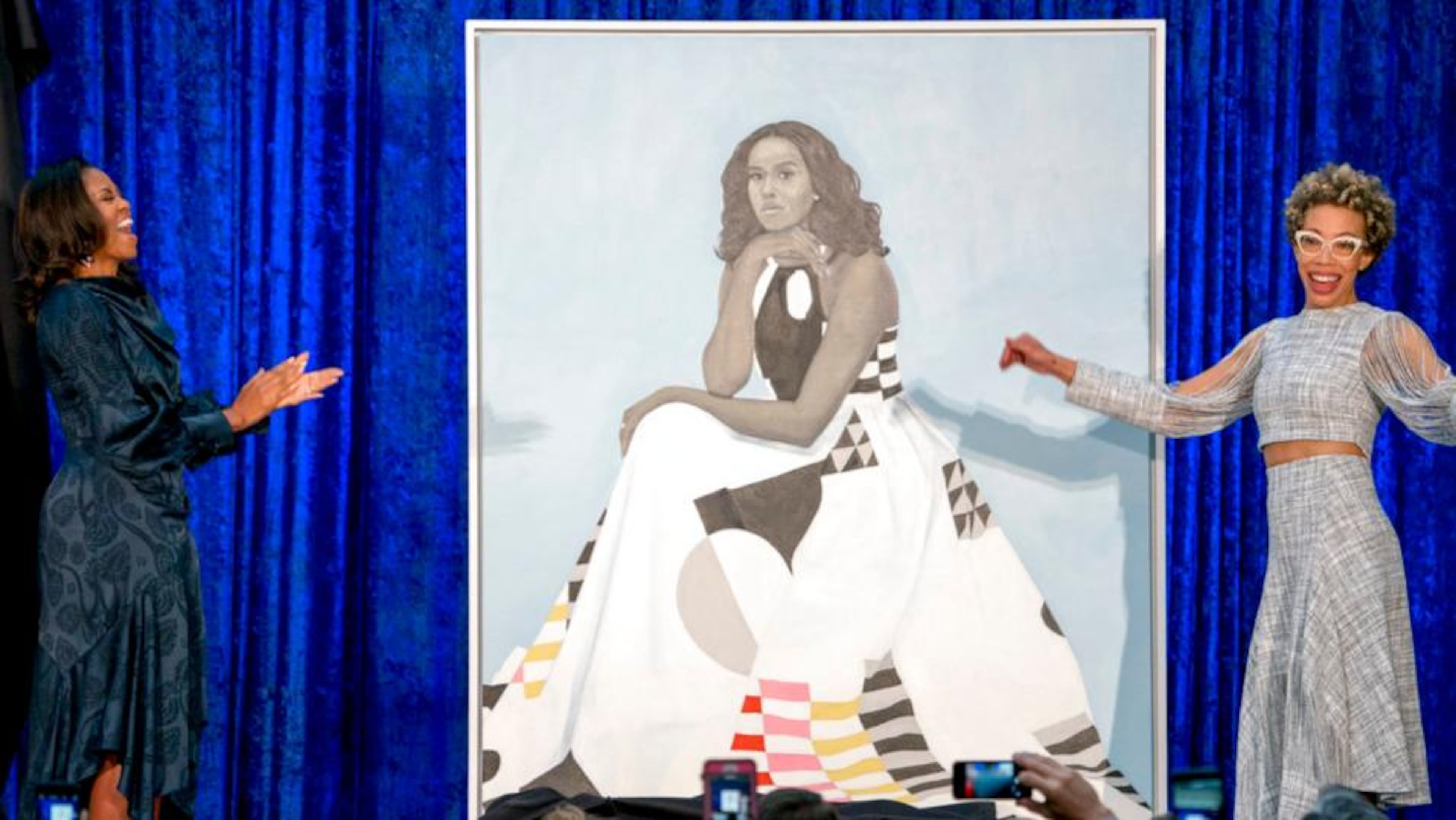 Former first lady Michelle Obama and artist Amy Sherald, right, unveil Michelle Obama's official portrait at the Smithsonian's National Portrait Gallery in February 2018 in Washington. (Andrew Harnik/AP)