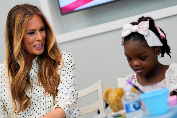 First lady Melania Trump talks with a girl while visiting Children's National Hospital, Thursday, July 3, 2025, in Washington. (AP Photo/Julia Demaree Nikhinson)
