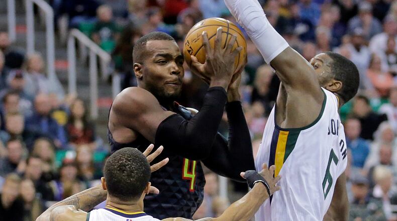 Utah Jazz’s Joe Johnson (6) and George Hill (3) defend against Atlanta Hawks forward Paul Millsap (4) in the first half during an NBA basketball game Friday, Nov. 25, 2016, in Salt Lake City. (AP Photo/Rick Bowmer)