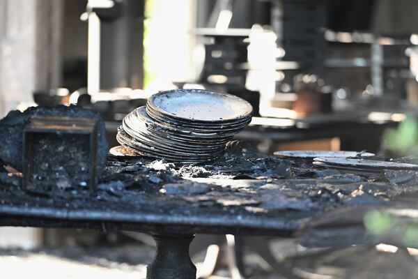 Charred tables and dishes are visible inside the Pennsylvania governor's official residence after a man was arrested in an alleged arson that forced Gov. Shapiro, his family and guests to flee in the middle of the night on the Jewish holiday of Passover, Sunday, Apr. 13, 2025, in Harrisburg, Pa. (AP Photo/Marc Levy)