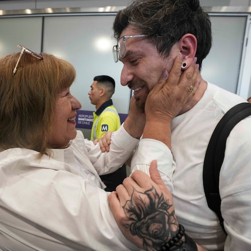 Kyle Adler, a 36-year-old Chilean American who was taken from his family at nine months old and illegally adopted, embraces his birth mother, Ana Maria Navarrete, after traveling from the U.S. to meet her for the first time, in Santiago, Chile, Saturday, Feb. 14, 2026. (AP Photo/Esteban Felix)