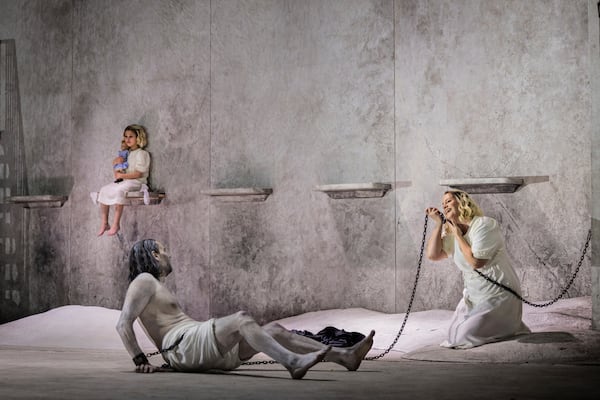 This image released by the Metropolitan Opera shows Peter Mattei as Jochanaan, foreground left, and Elza van den Heever in the title role of Strauss's "Salome" in New York on April 21, 2025. (Evan Zimmerman/Met Opera via AP)