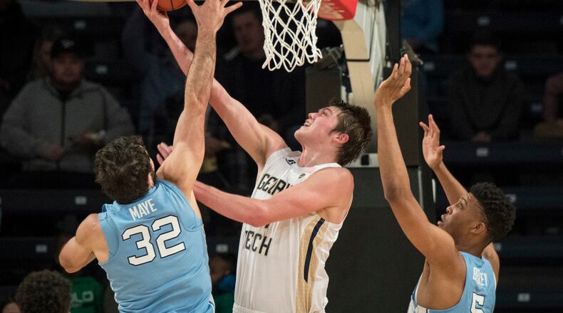 Georgia Tech center Ben Lammers (44) shoots as North Carolina forward Luke Maye (32), and forward Tony Bradley (5) defend during the first half of an NCAA college basketball game, Saturday, Dec 31, 2016, in Atlanta. (AP Photo/John Amis)