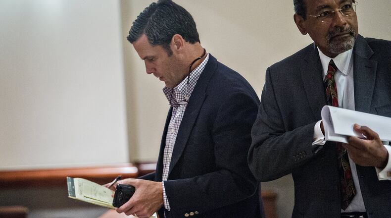 Rick Warren (left) walks out of court on bond with his attorney George Lawson after his hearing at Atlanta Municipal Court on Tuesday. Warren was found guilty on two counts of housing code violations on two different properties he owns, and not guilty on three counts at a third property. JONATHAN PHILLIPS / SPECIAL