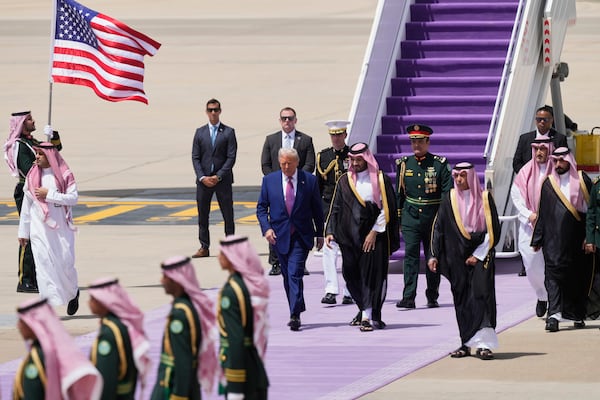 President Donald Trump walks with Saudi Crown Prince Mohammed bin Salman during an arrival ceremony at the Royal Terminal of King Khalid International Airport in Riyadh, Saudi Arabia, Tuesday, May 13, 2025
