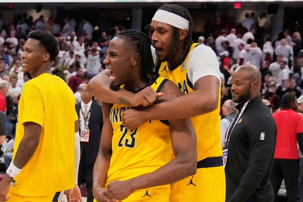 Indiana Pacers forward Aaron Nesmith (23) and center Myles Turner, right, celebrate after the Pacers defeated the Cleveland Cavaliers in Game 2 in the Eastern Conference semifinals of the NBA basketball playoffs Tuesday, May 6, 2025, in Cleveland. (AP Photo/Sue Ogrocki)