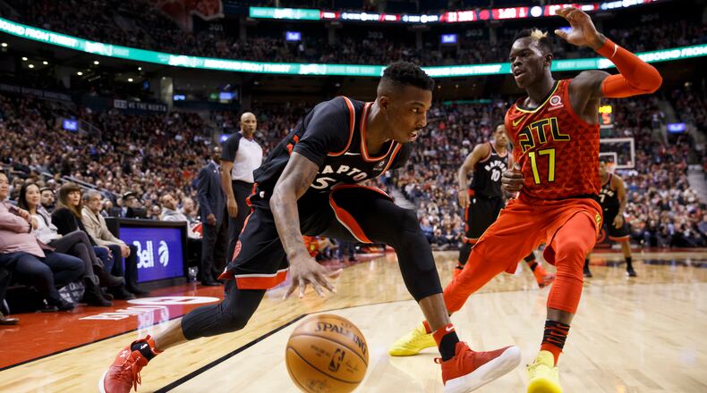 Toronto Raptors guard Delon Wright (55) drives against Atlanta Hawks guard Dennis Schroeder (17) during the second half of an NBA basketball game Friday, Dec. 29, 2017, in Toronto. (Cole Burston/The Canadian Press via AP)