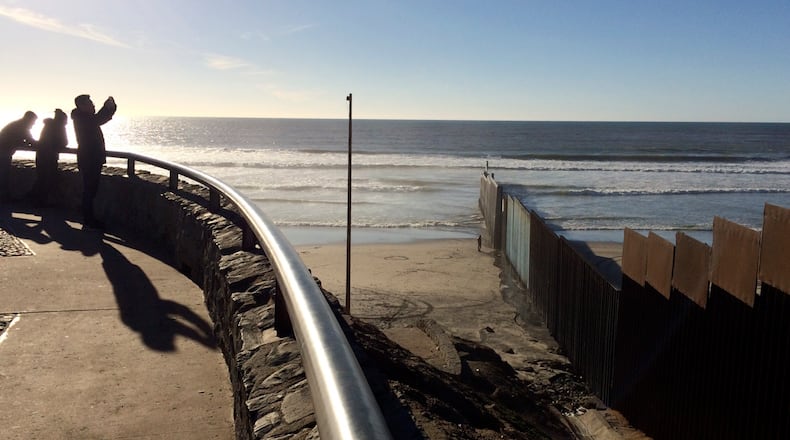 People look out towards where border structure separates San Diego, right, from Tijuana, Mexico, left, Wednesday, Jan. 25, 2017. President Donald Trump moved aggressively to tighten the nation's immigration controls Wednesday, signing executive actions to jumpstart construction of his promised U.S.-Mexico border wall and cut federal grants for immigrant-protecting "sanctuary cities." (AP Photo/Julie Watson)