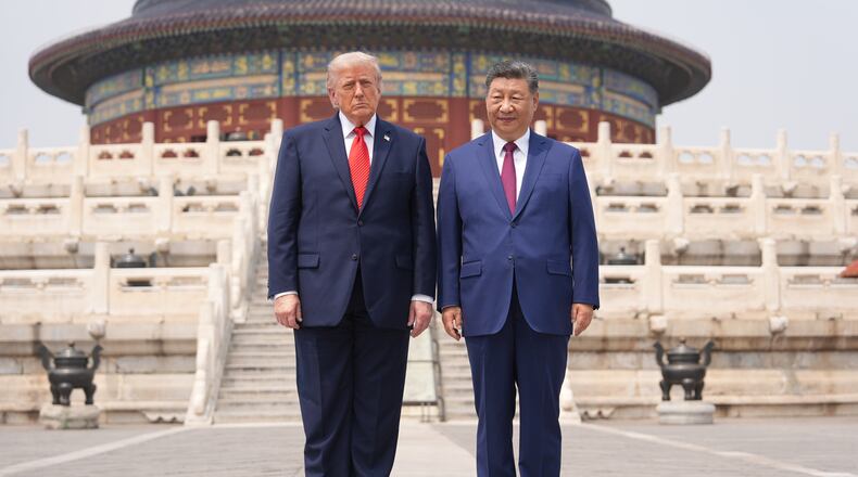 President Donald Trump, left, stands with Chinese President Xi Jinping at the Temple of Heaven on Thursday May 14, 2026, in Beijing. (AP Photo/Mark Schiefelbein)