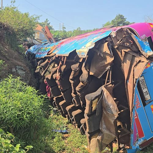 A bus lies on the side of the road Friday, July 17, 2026, after it crashed Thursday night in the the Kapchorwa District in eastern Uganda. (AP Photo)