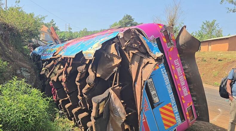 A bus lies on the side of the road Friday, July 17, 2026, after it crashed Thursday night in the the Kapchorwa District in eastern Uganda. (AP Photo)