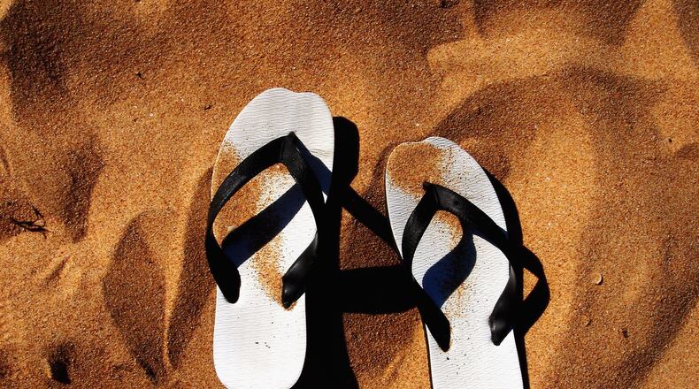 SYDNEY, NSW - JANUARY 21:  A pair of thongs lie in the sand on a beach January 21, 2006 in Sydney, Australia. Thongs, also known as "Flip Flops" in Europe or "Jandals" in New Zealand, are a common form of footware worn widely across Australia. The nation will celebrate Australia Day on January 26.   (Photo Illustration by Ian Waldie/Getty Images)