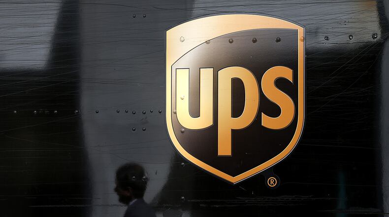 A pedestrian walks by a United Parcel Service (UPS) truck on June 17, 2014 in San Francisco, California. (Photo by Justin Sullivan/Getty Images)