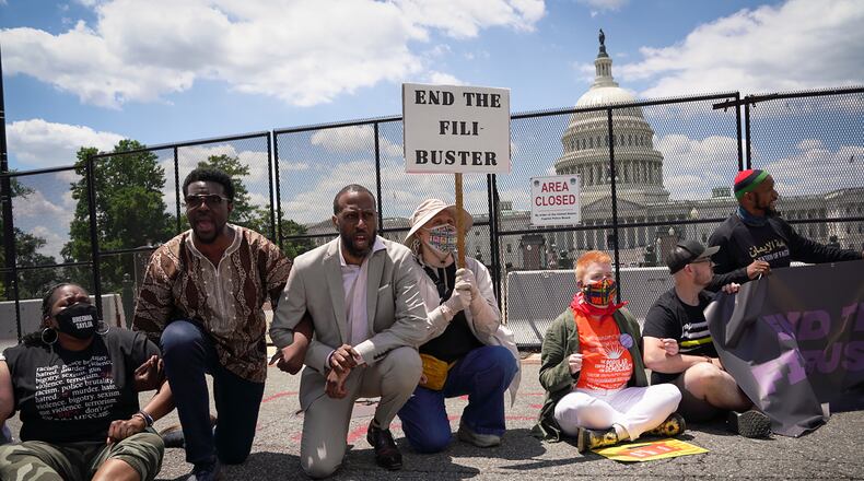 Protesters block a street between the Capitol and the Supreme Court building in Washington, demonstrating for the passage of the For the People Act, and an end to the filibuster. (Sarahbeth Maney/The New York Times)