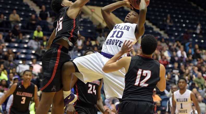 Naquante Hardy (10) of Miller Grove shoots against Allatoona defenders in the Class AAAAA boys championship at the Macon Coliseum on Friday, March 4, 2016. KENT D. JOHNSON/ kdjohnson@ajc.com