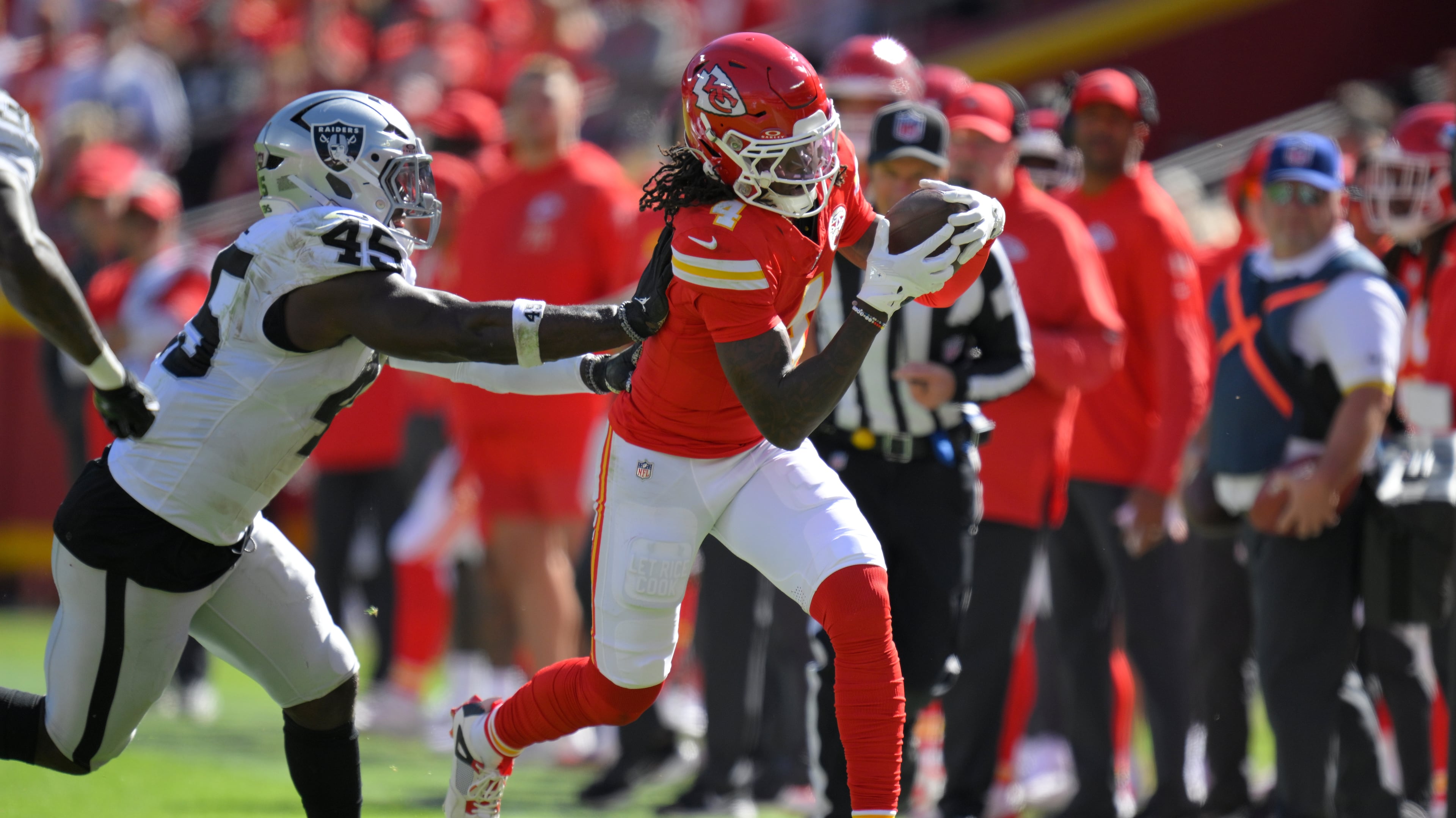 Kansas City Chiefs wide receiver Rashee Rice (4) is pushed out of bounds by Las Vegas Raiders linebacker Devin White (45) during the first half of an NFL football game Sunday, Oct. 19, 2025, in Kansas City, Mo. (AP Photo/Reed Hoffmann)